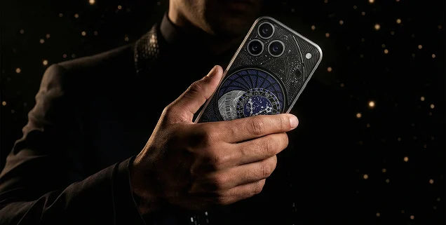 Кастомный iPhone Caviar с художественной панелью в руке на тёмном фоне со звёздами